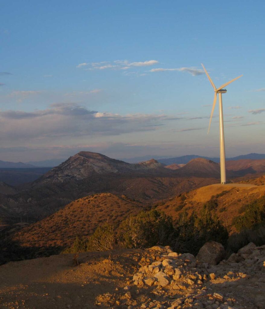 Sunrise over onshore wind turbine on mountain